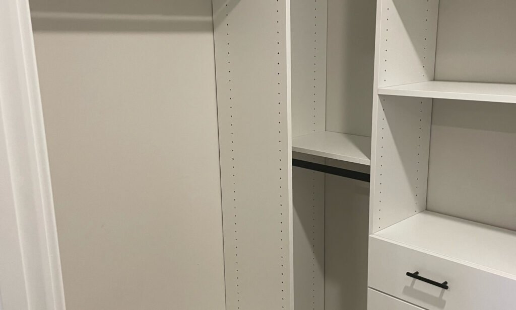 Walk-in closet with black hardware